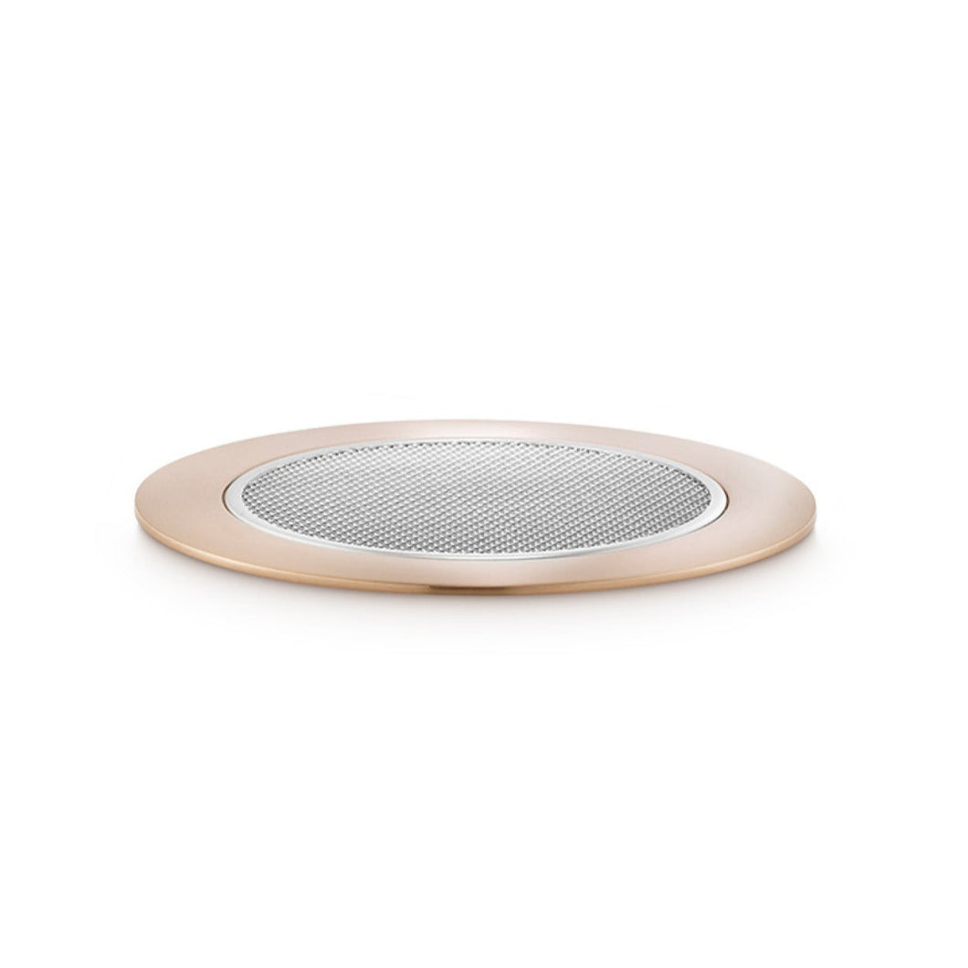 Round metallic object on a white background